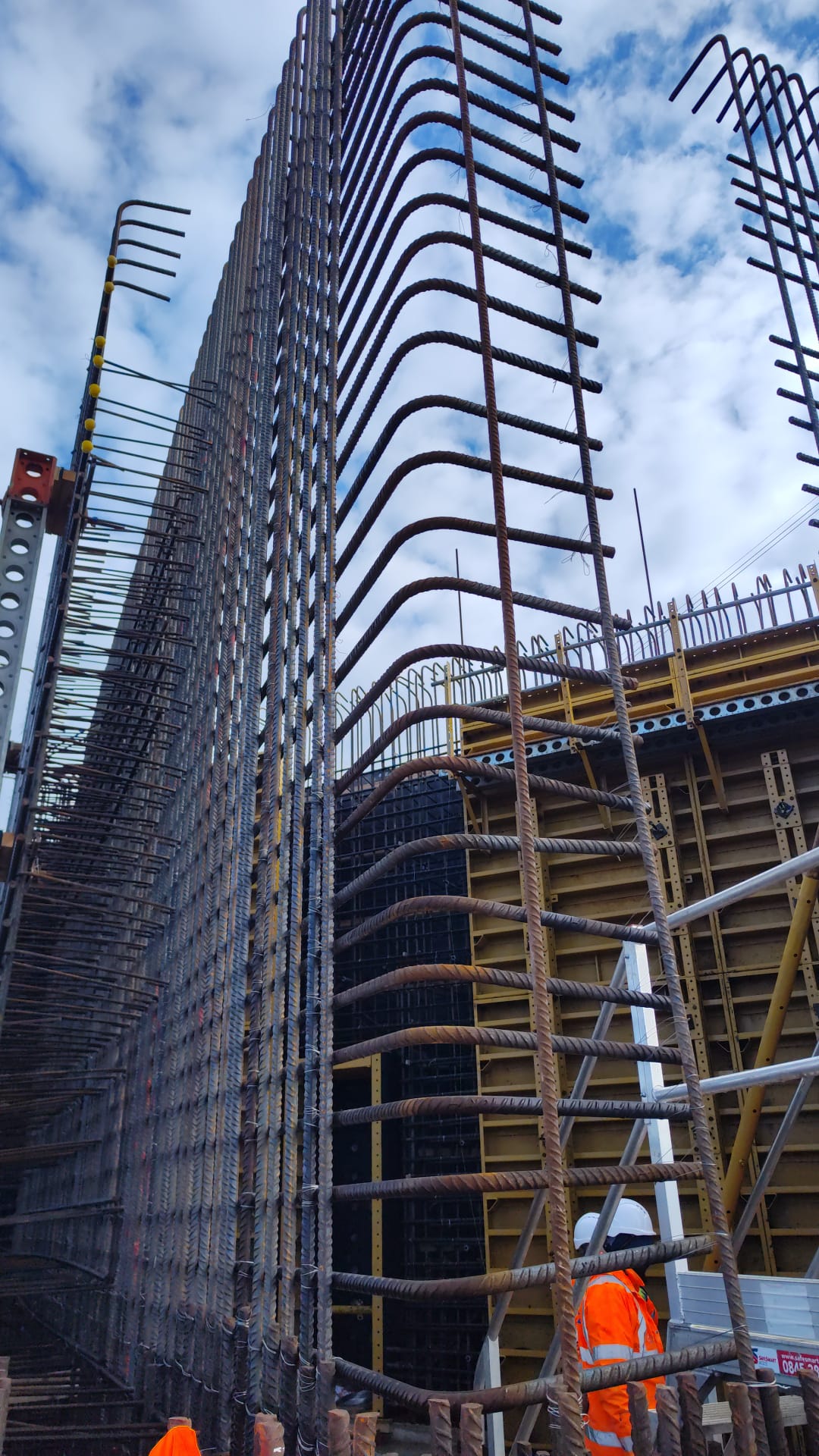 Towering rebar wall viewed from below